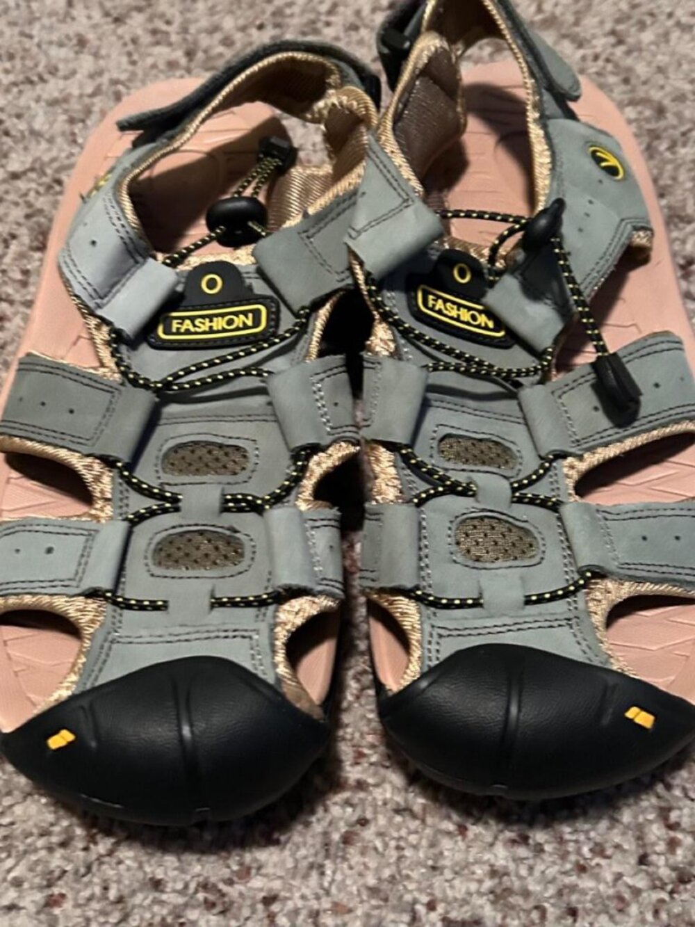 Gray and black sandals with yellow accents